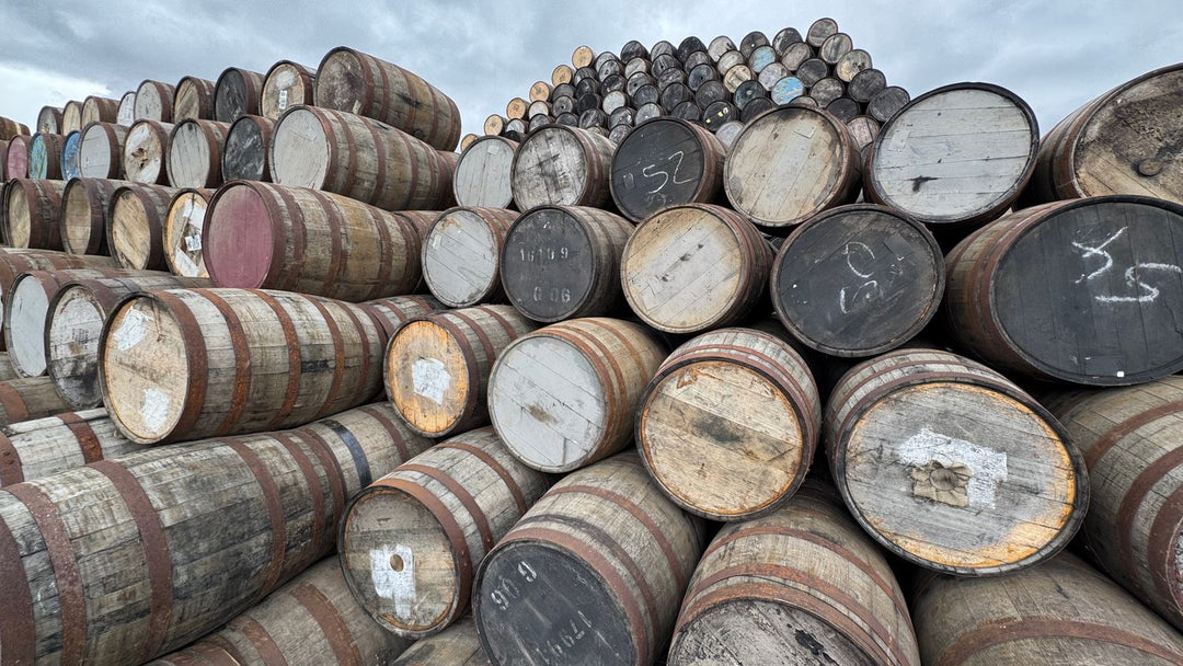 Rows of oak whisky casks at a distillery, where cask strength spirit comes from