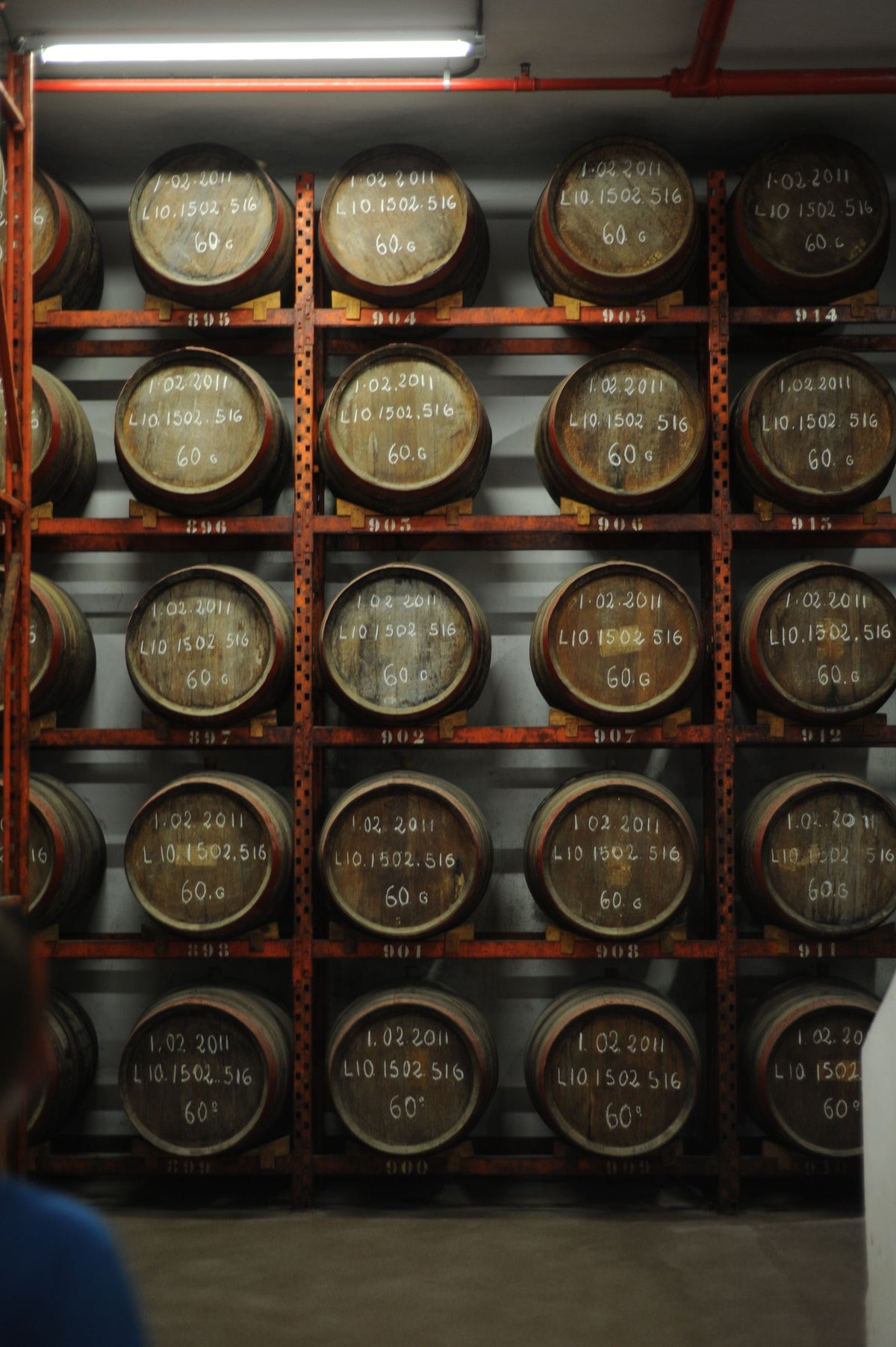 Stacked oak barrels in a rum aging warehouse