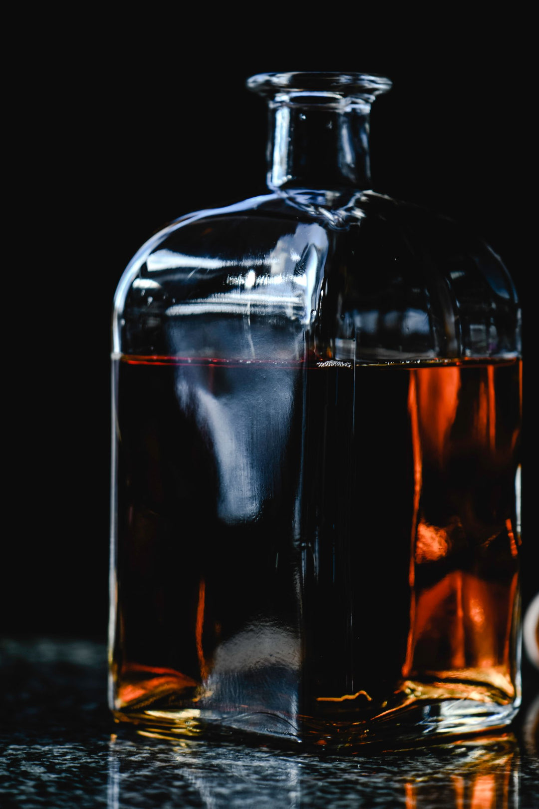 Spirit in a glass decanter beside a filled glass